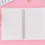 A self-care bullet journal on a pink background